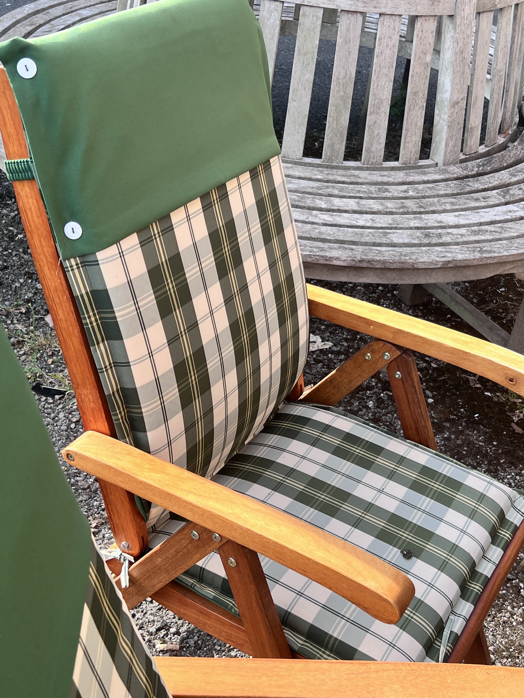 A stained teak extending garden table, length 150cm, depth 100cm, height 76cm, together with six Deuba teak folding garden chairs with cushions